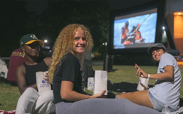 Students watching a movie at Cannon Green